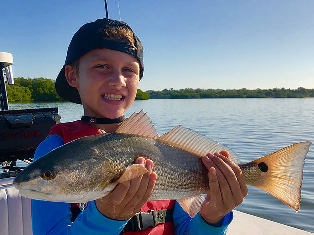 a redfish that a child is holding