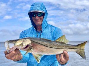 The author holds a nice snook caught on the flats