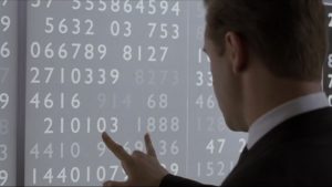 A man looking at numbers trying to get a pattern