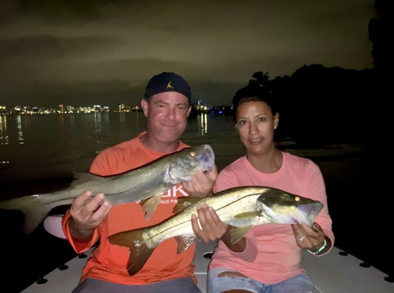 Two angers hold snook up for the camera