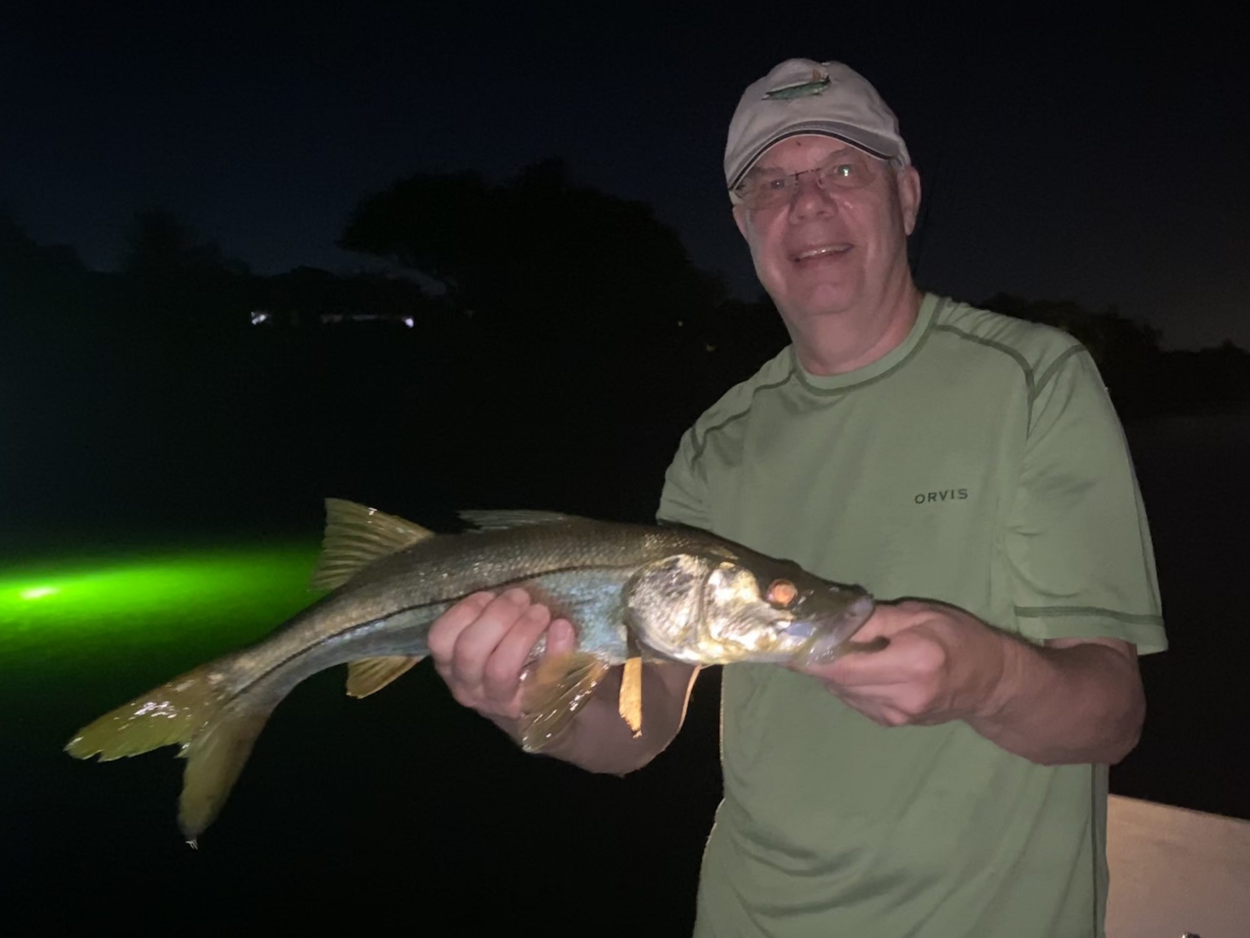 An angler holds up a snook