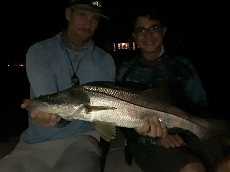 The author holds a snook that a rookie angler caught