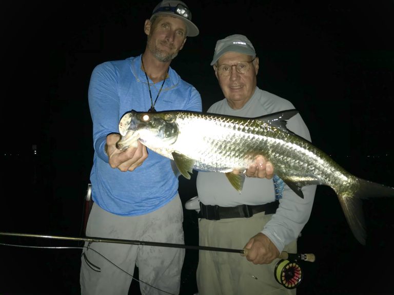 the author holds a tarpon up for the camera