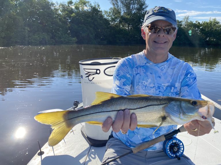 an angler holds a snook