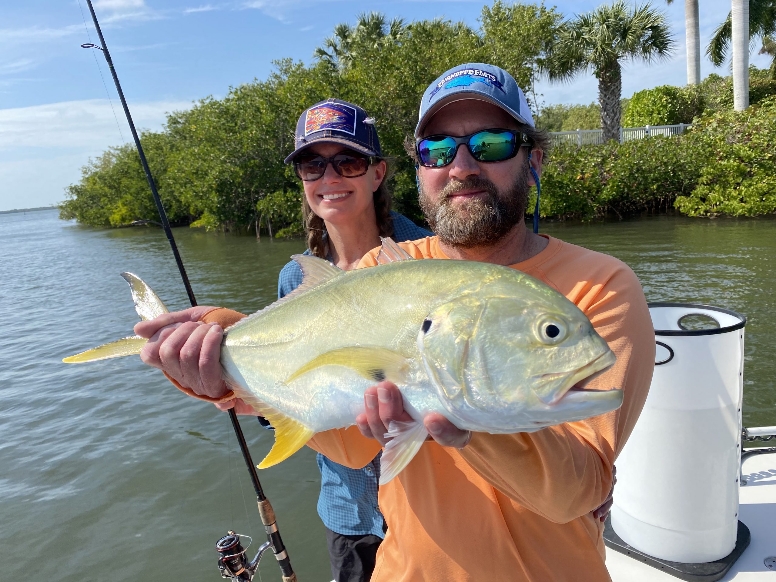 An angler holds a jack crevalle caught on spinning gear