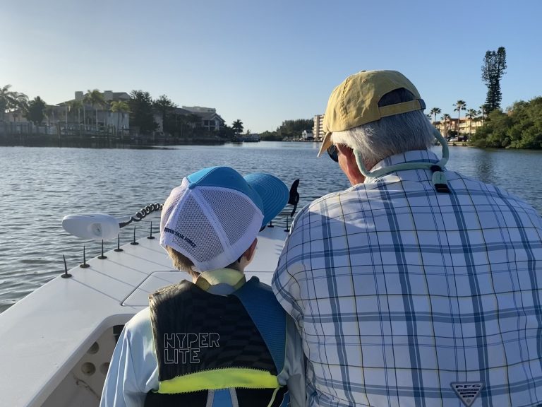 A grandfather and grandson head out on a fishing trip together