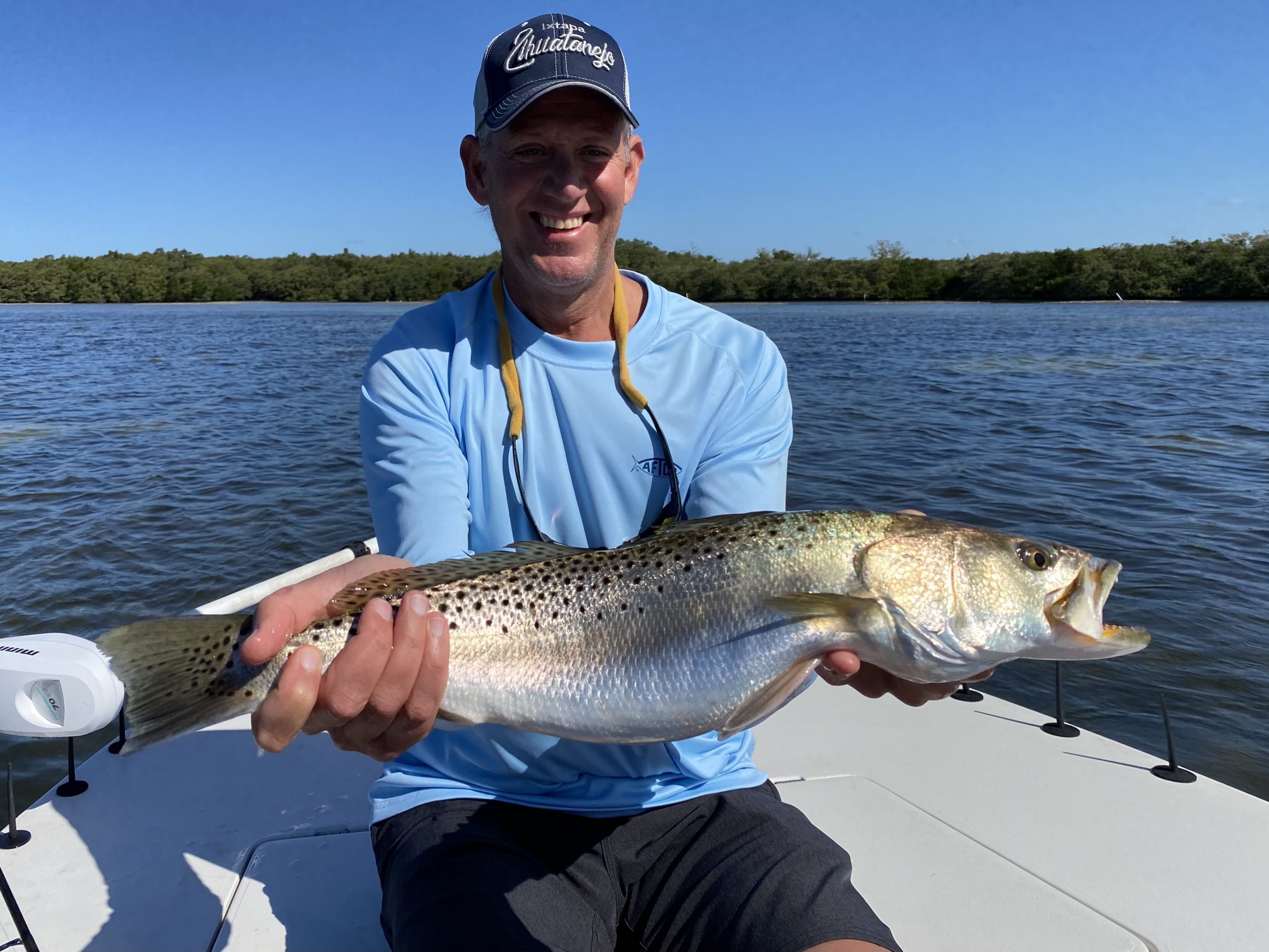 An angler holds a nice seatrout out for the camera
