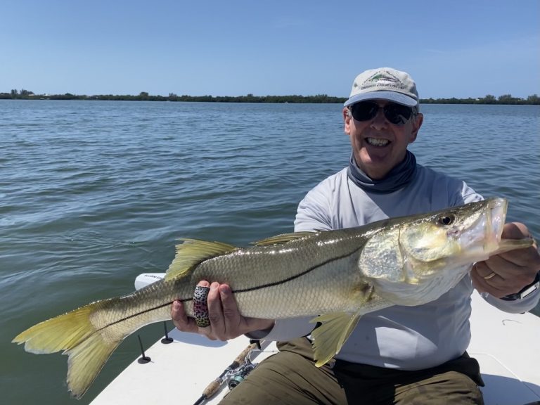 A big snook is held up for the camera