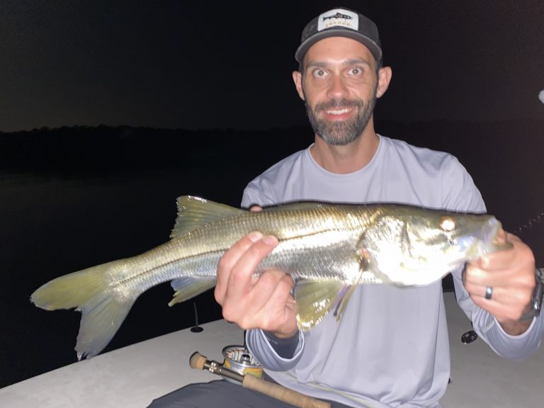 An angler holds a snook he caught