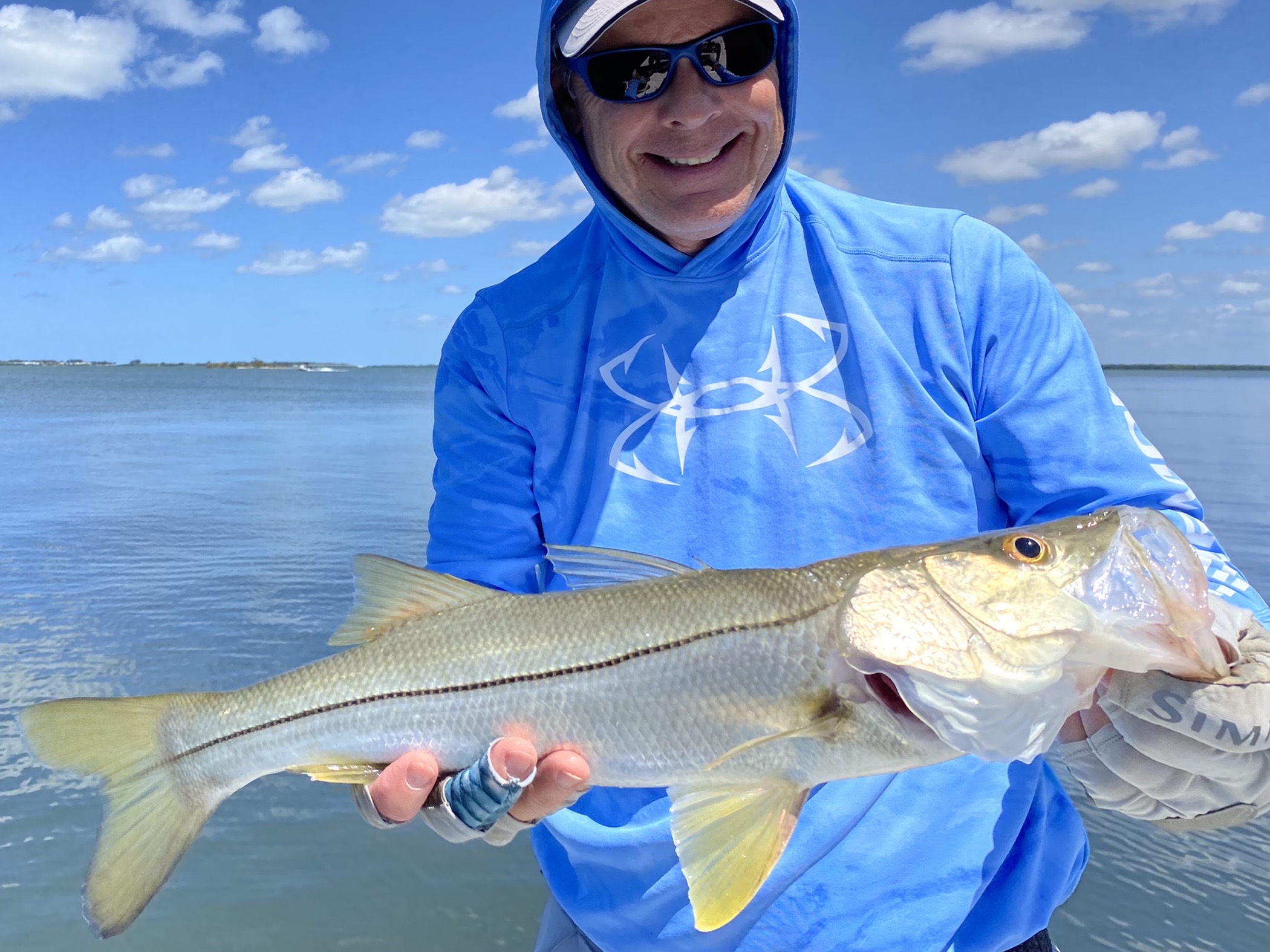 An angler smiles at a snook he caught