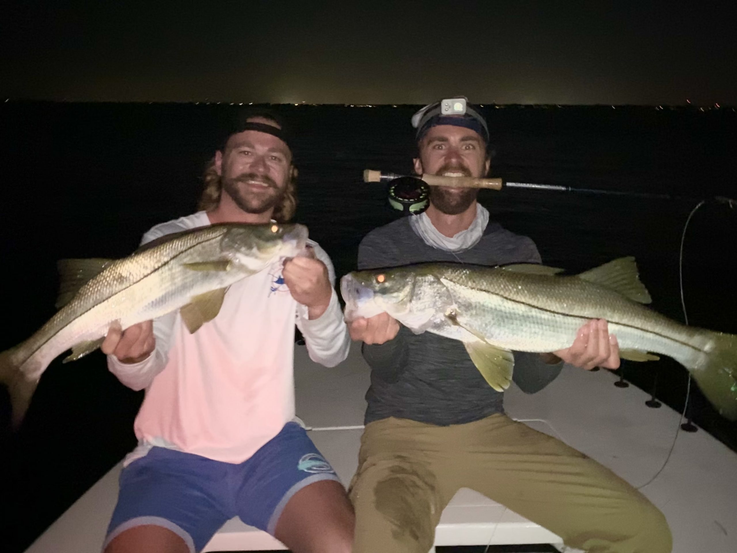 Two anglers hold snook up for the camera