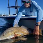 An angler releases a redfish that he sight fished