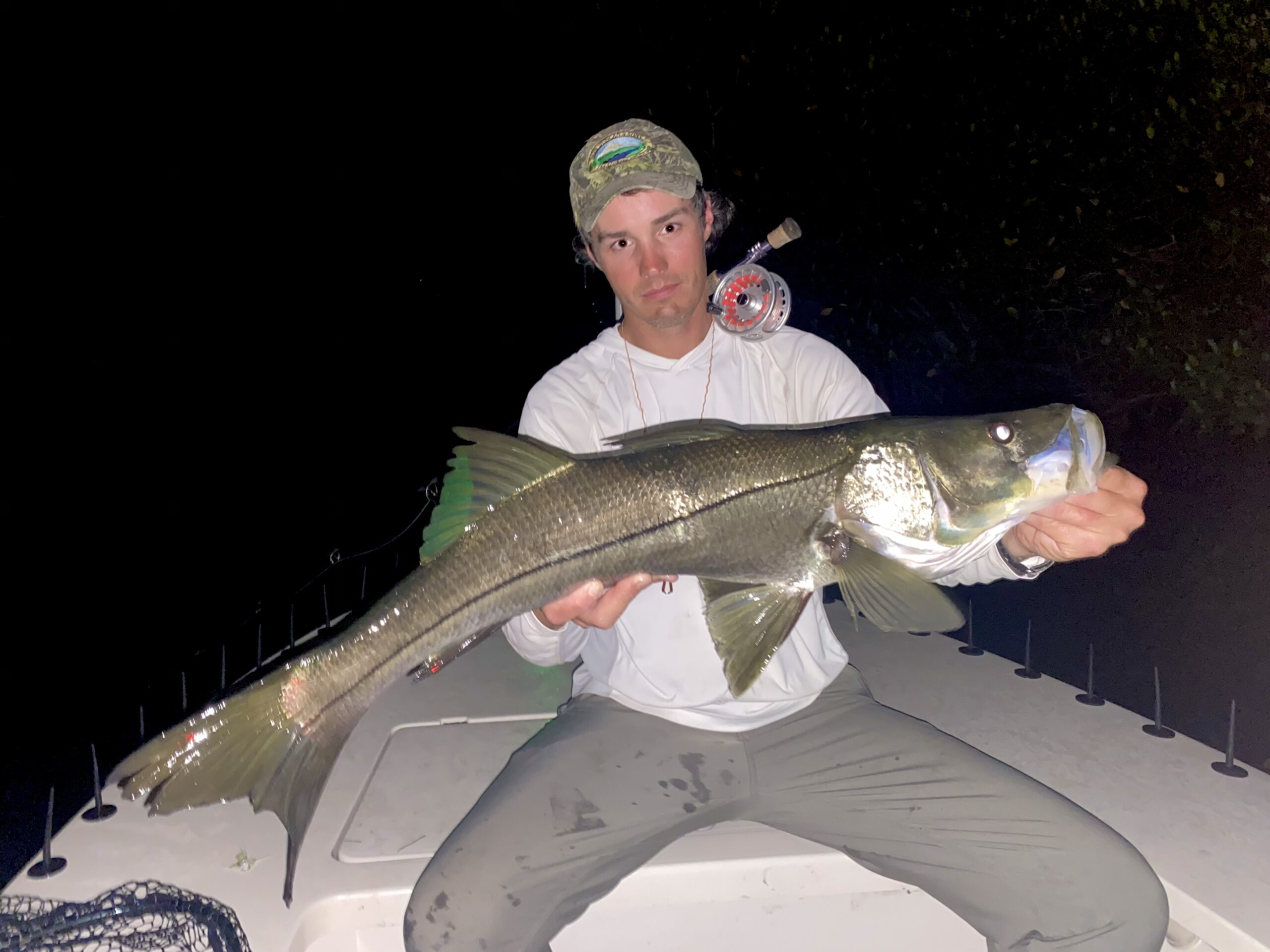 An angler holds a snook up for the camera