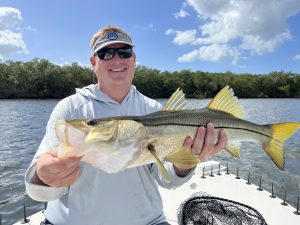An angler holds up a beautiful back country snook caught in tampa bay