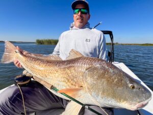 An angler holds a giant redfish