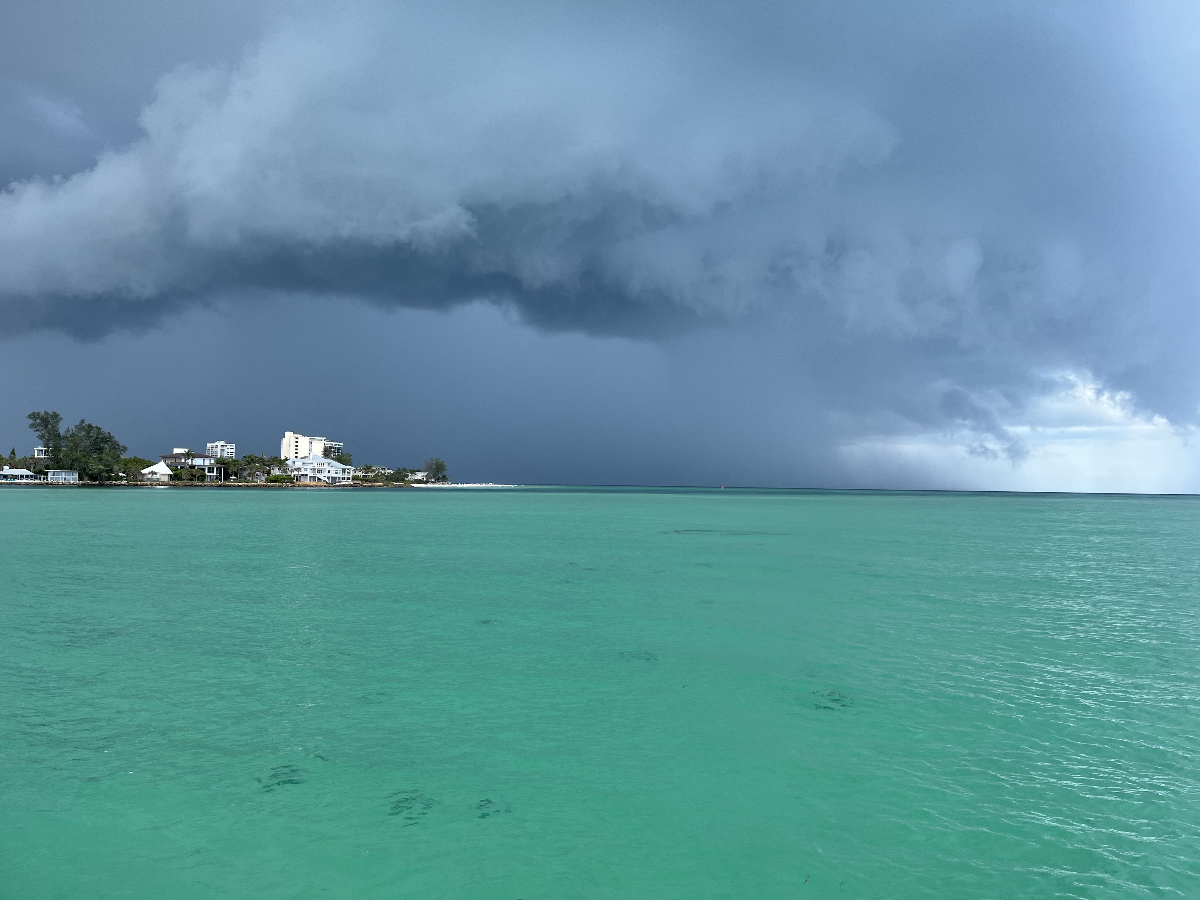 Rain clouds move towards land over the Gulf